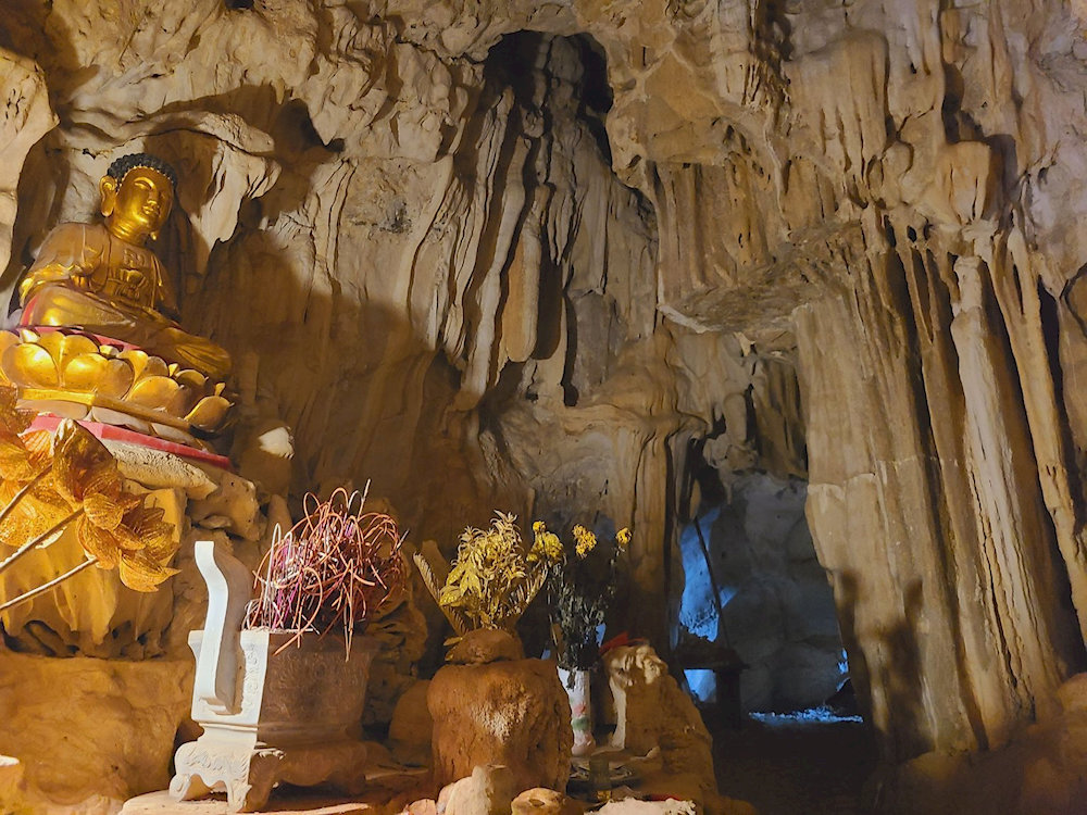 Light streams through a natural skylight, illuminating the sacred altar inside